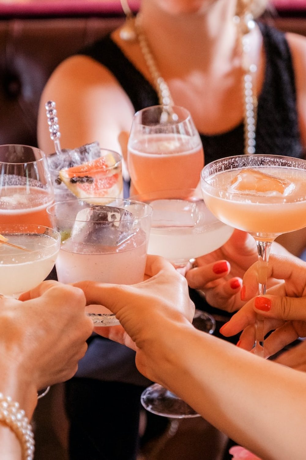 woman in black tank top holding clear wine glass